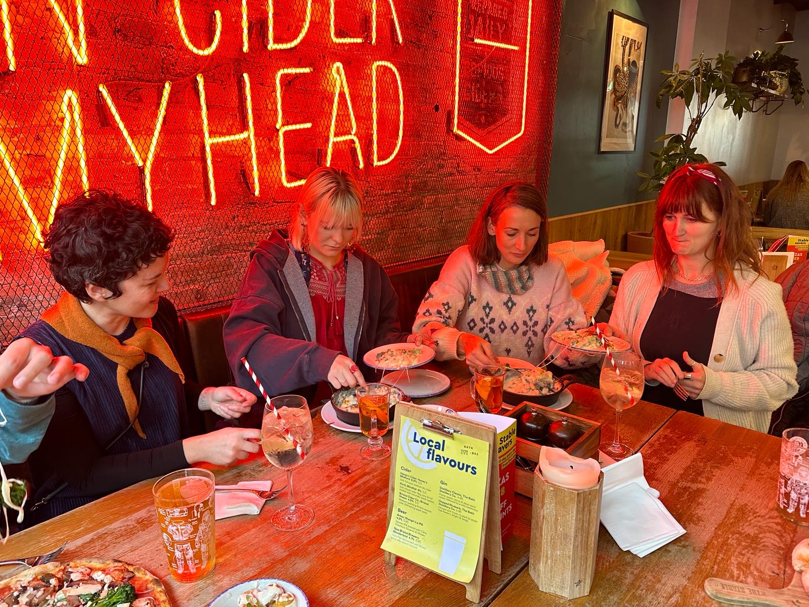 Gaelle, Connie, Laura and Hannah sharing food in a restaurant in Bath