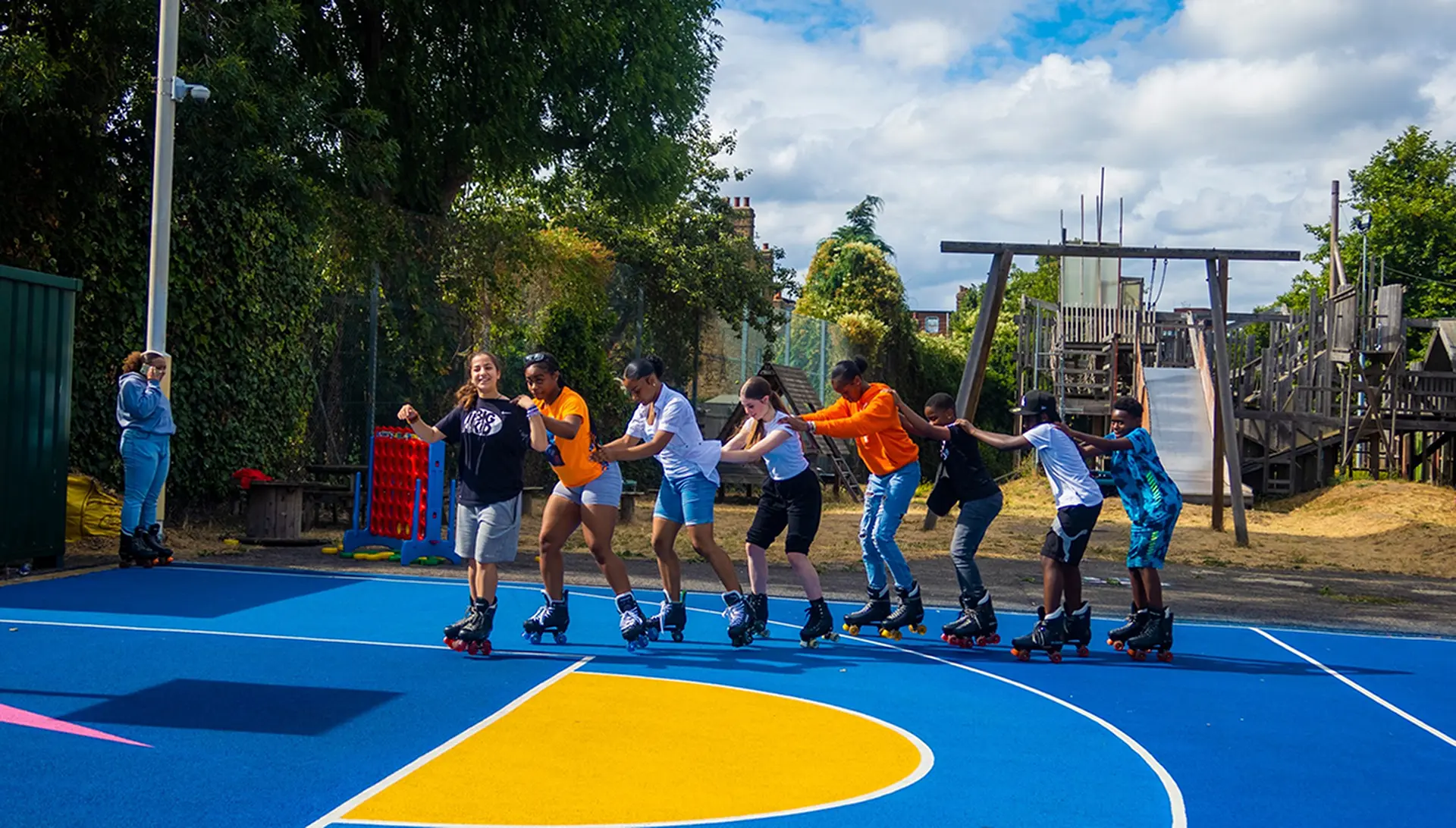 Image of children rollerskating at a sports facility